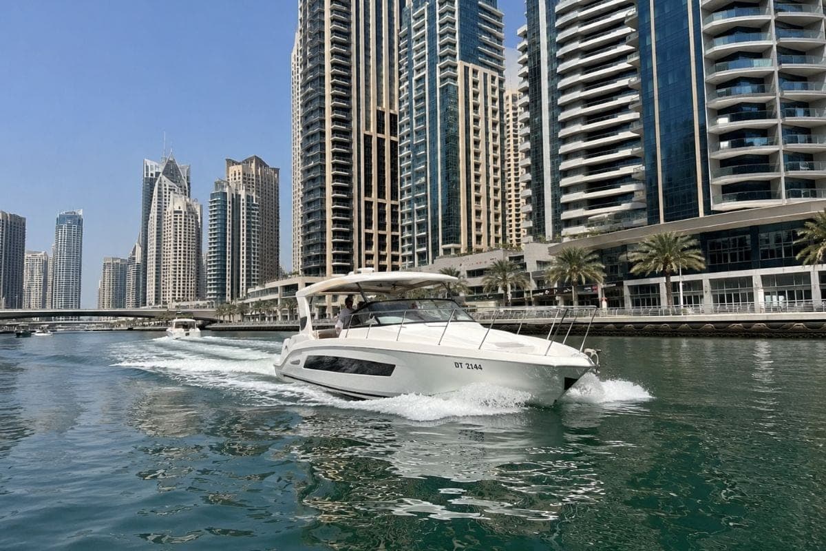 Private motor yacht cruising through Dubai Marina