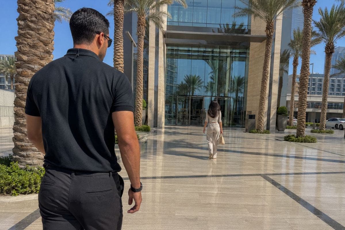 Private security service in Dubai: bodyguard escorting a guest across a hotel forecourt